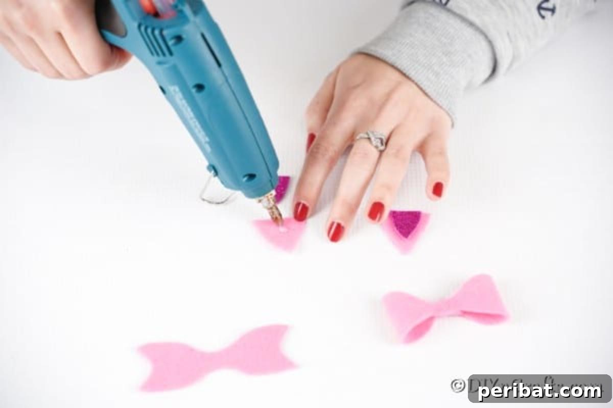 Gluing glitter foam triangles onto solid felt triangles