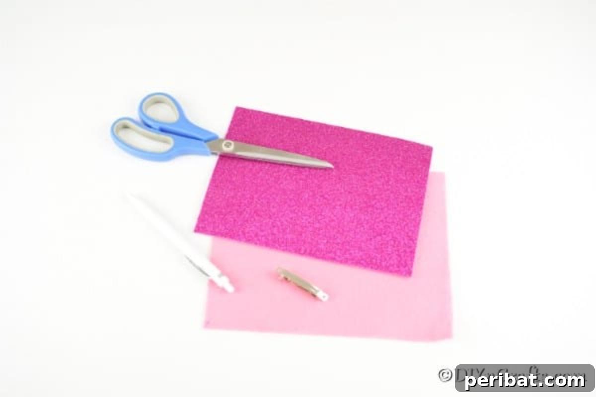 Flat lay image showing all supplies needed for the no-sew hair bow: felt, glitter foam, barrette, scissors, and pen