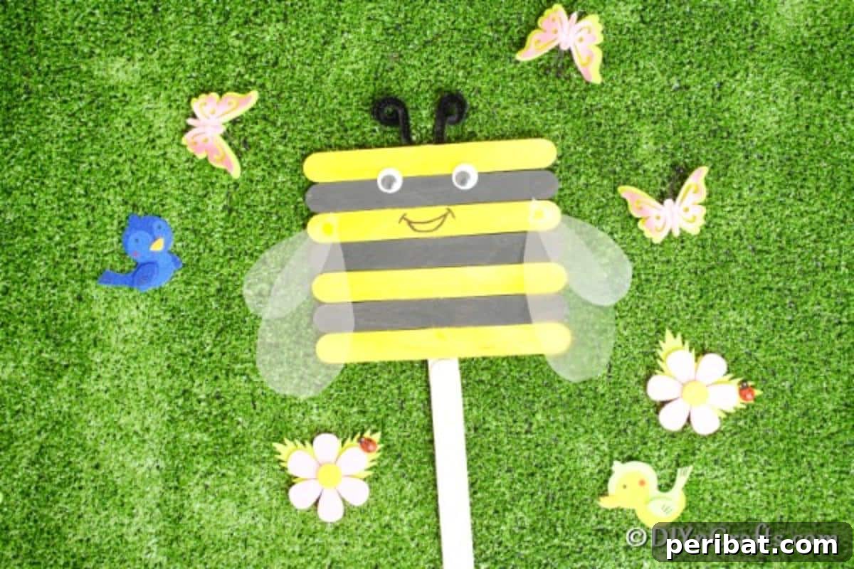 A charming craft stick bee sitting on lush green grass, highlighting its role as a delightful spring or summer garden decoration.