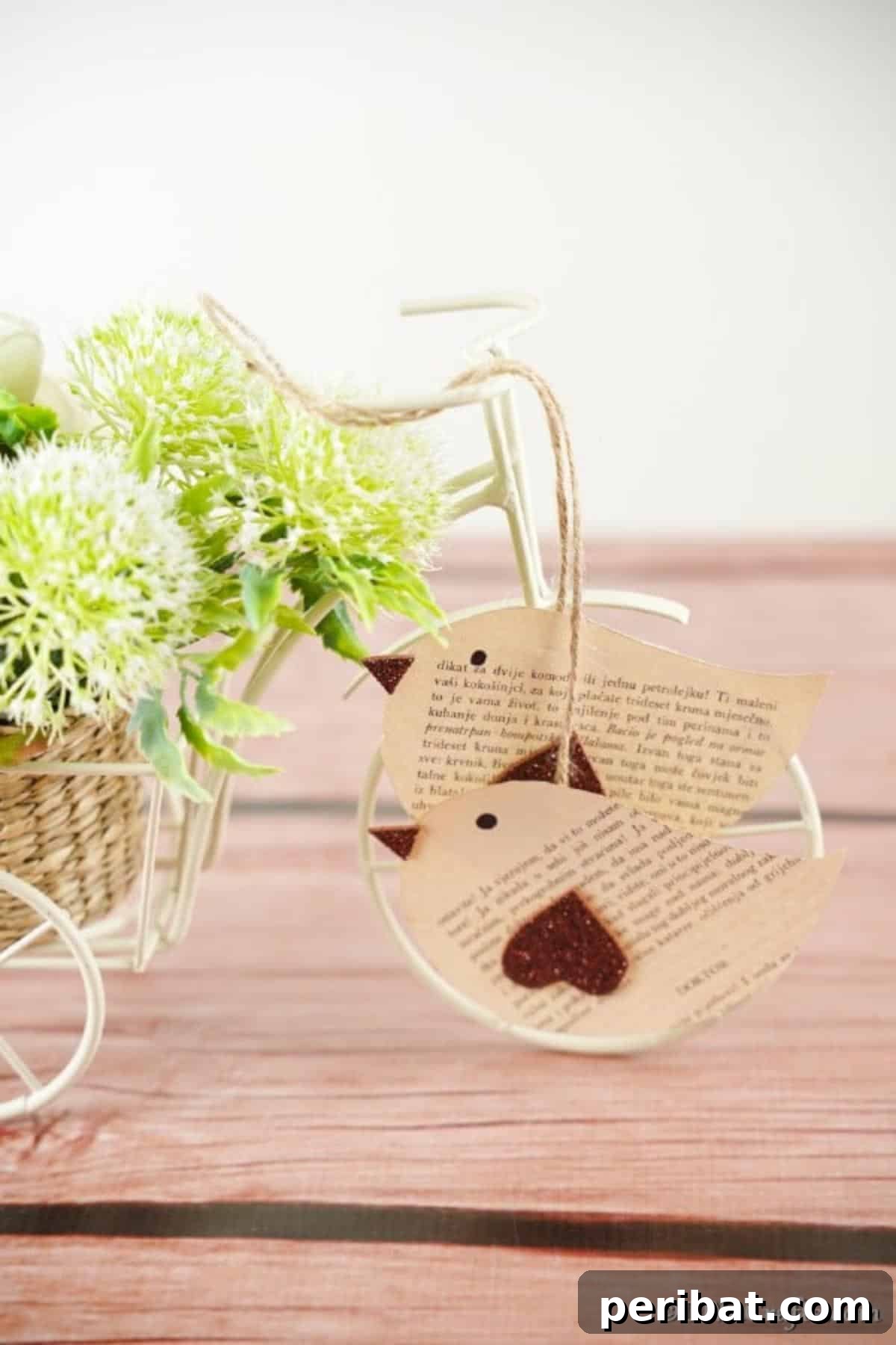 DIY Vintage Book Page Bird Wall Art 5 A collection of handmade book page birds perched on a small wire utility cart, demonstrating various display options for these rustic crafts.