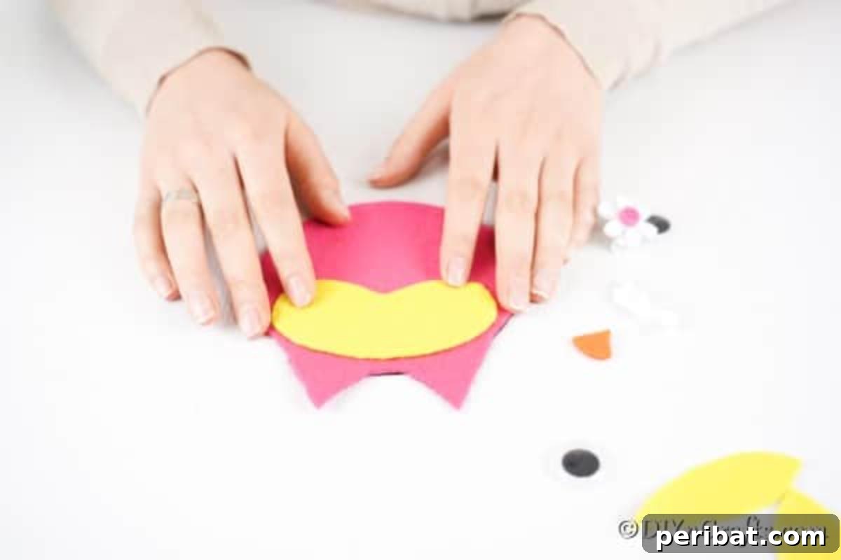 Craft a Whimsical CD Owl Wall Decor 12 Gluing face onto owl