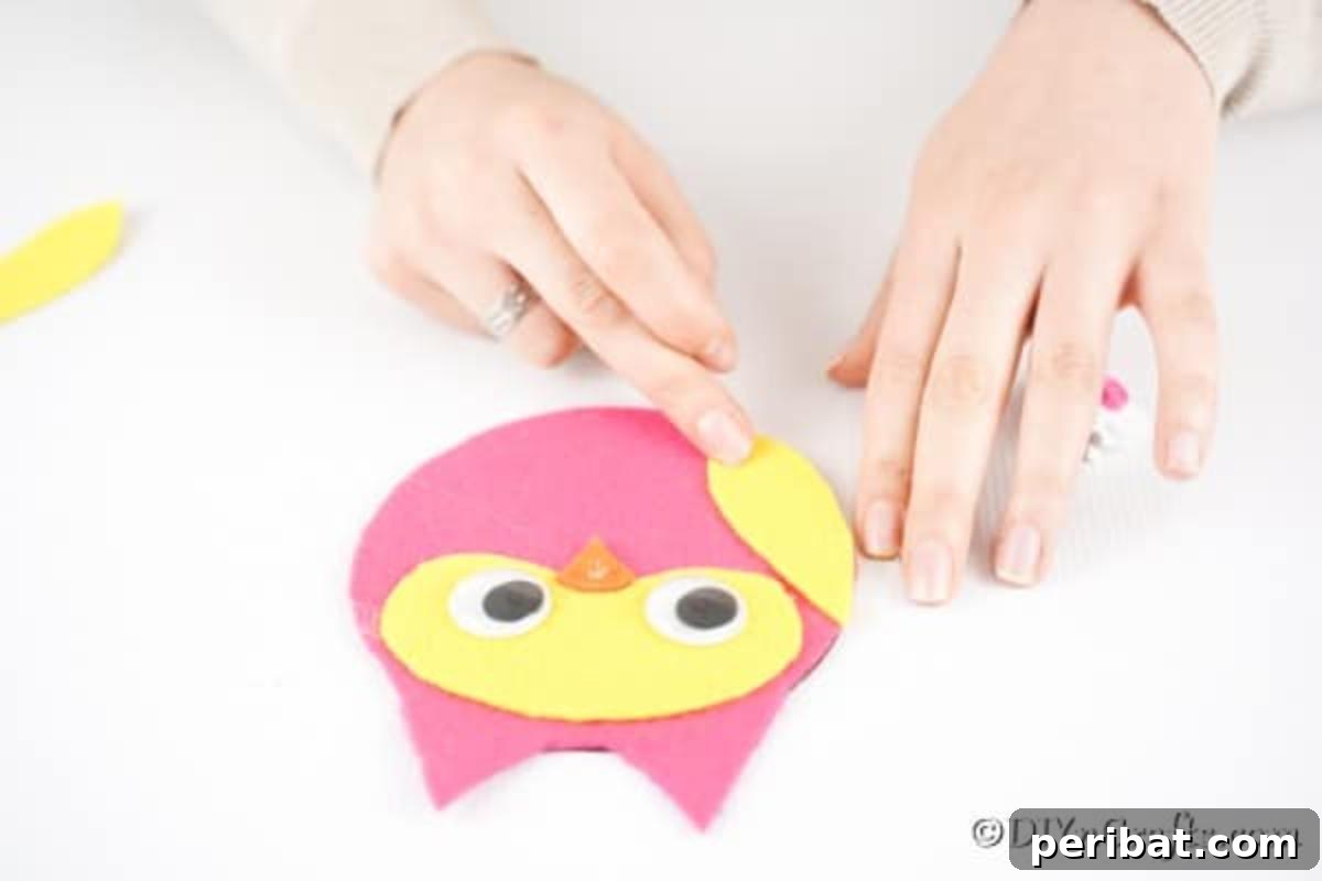 Craft a Whimsical CD Owl Wall Decor 14 Gluing wings onto owl