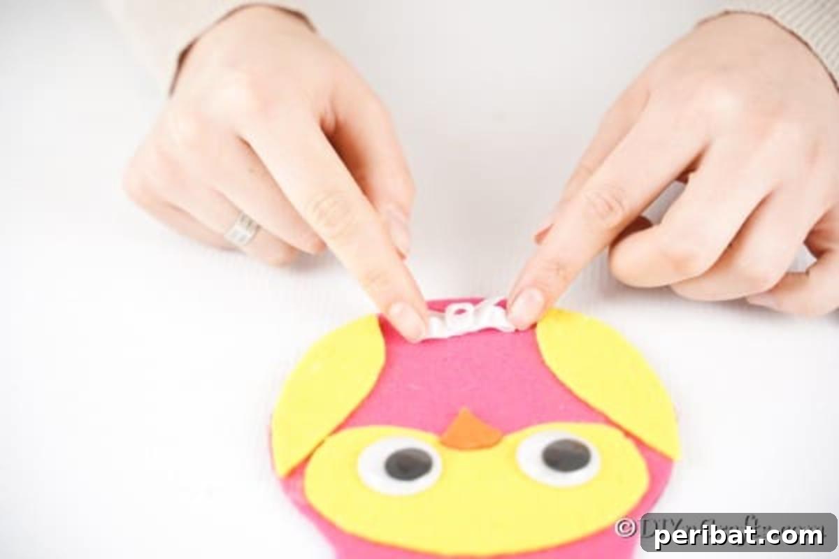 Craft a Whimsical CD Owl Wall Decor 15 Adding bow to bottom of owl