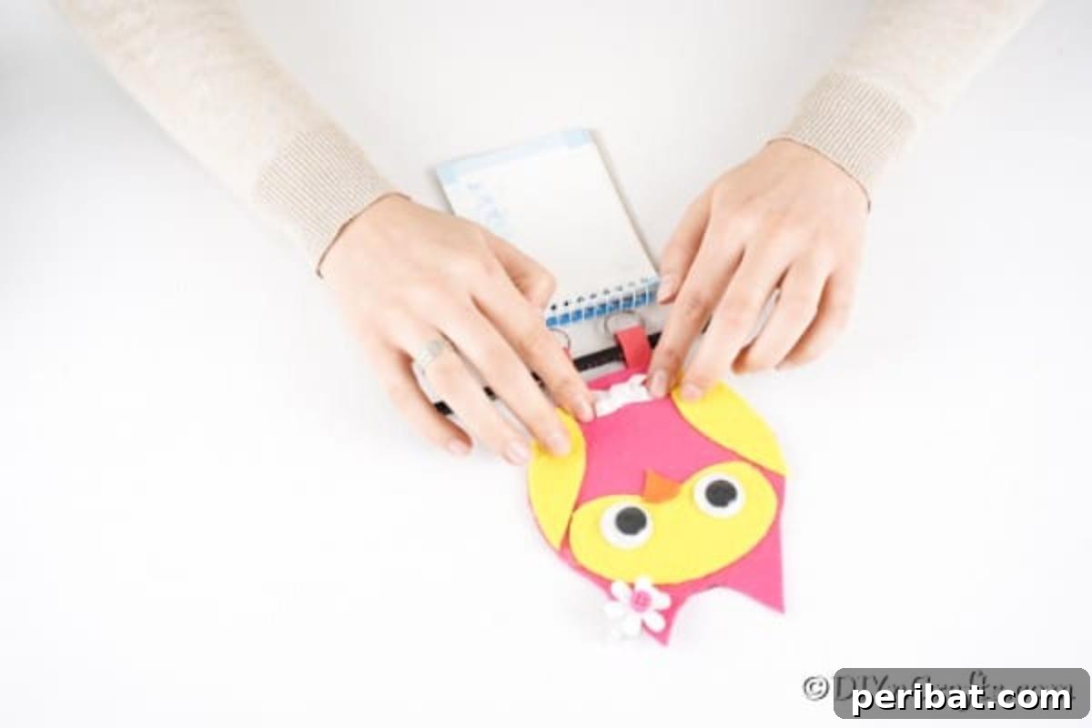 Craft a Whimsical CD Owl Wall Decor 20 Gluing legs in place on CD owl messenger pad