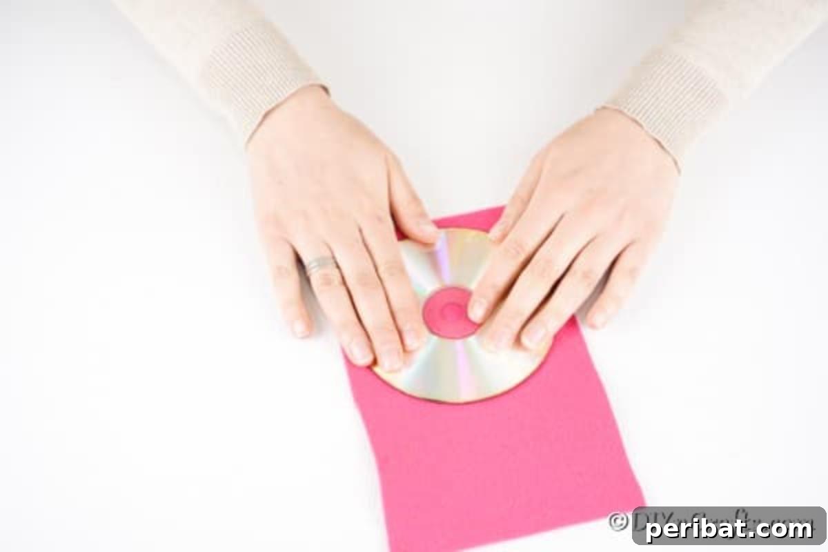 Craft a Whimsical CD Owl Wall Decor 9 Tracing circle onto pink felt