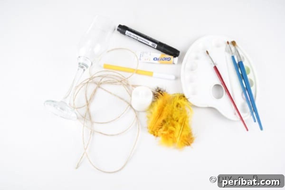 Adorable DIY Chick Wine Glass Luminary 8 A neatly arranged collection of supplies needed for crafting a wine glass chick candle holder, including paint, feathers, markers, and a wine glass.