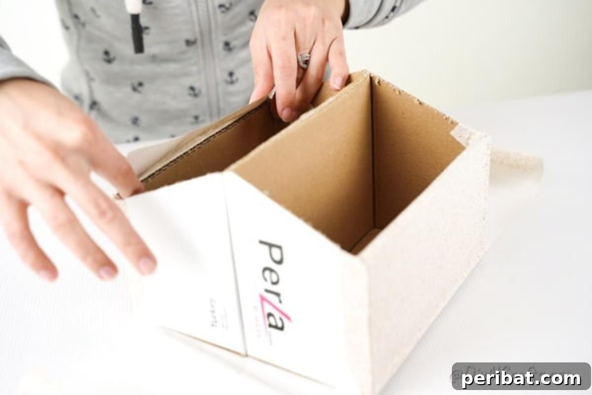 Charming Repurposed Cardboard Organizer 17 Method of applying contact paper to the box, ensuring smooth coverage and proper folding over the top edges