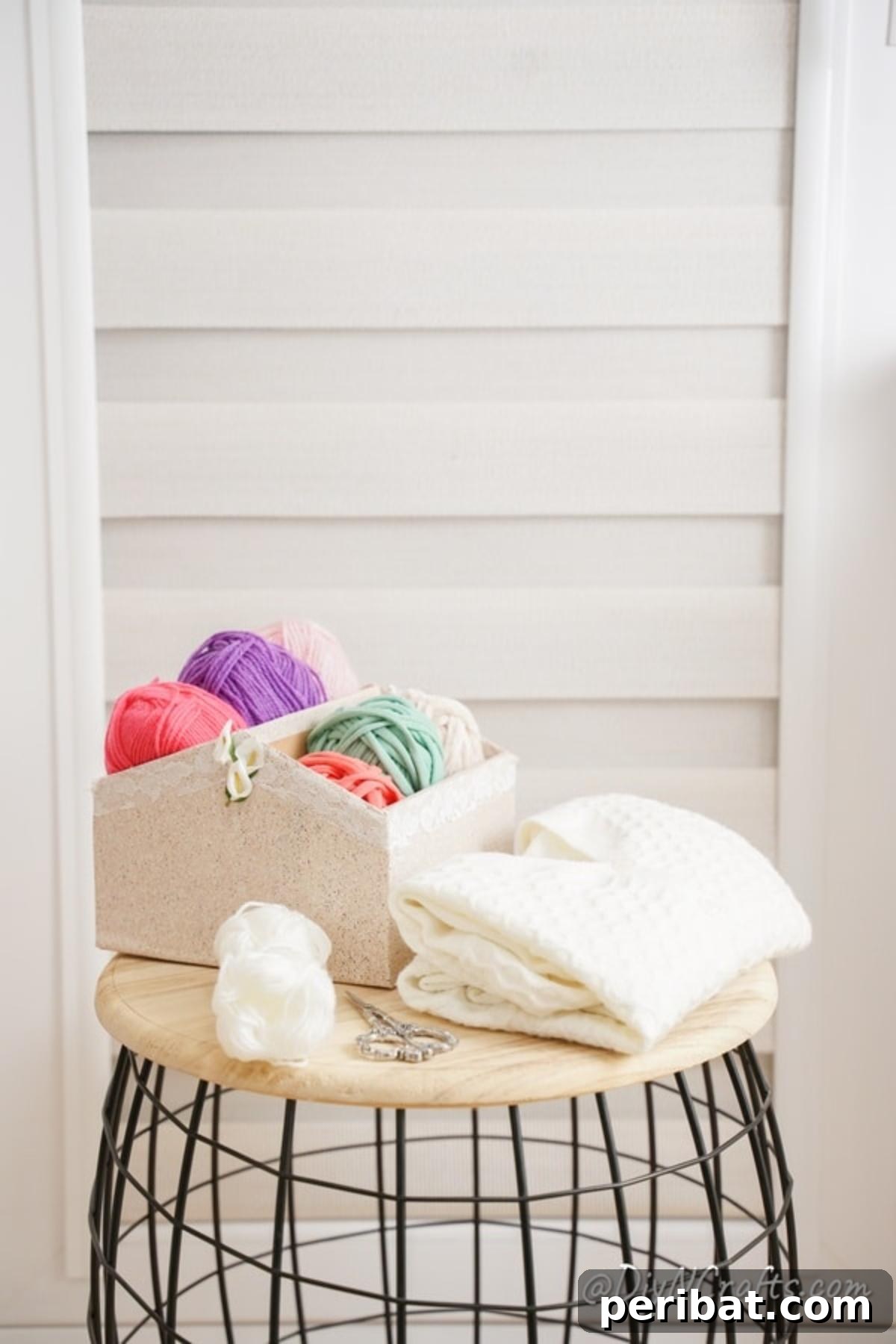 Charming Repurposed Cardboard Organizer 4 DIY organizer box filled with colorful yarn, sitting elegantly on a stylish wood and wire side table