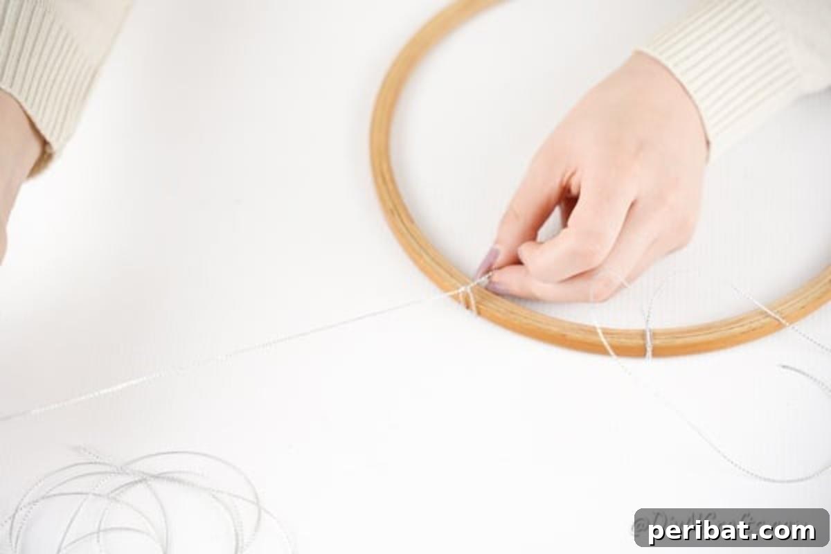 Whimsical Valentine Heart Mobile 11 Tying twine onto embroidery hoop