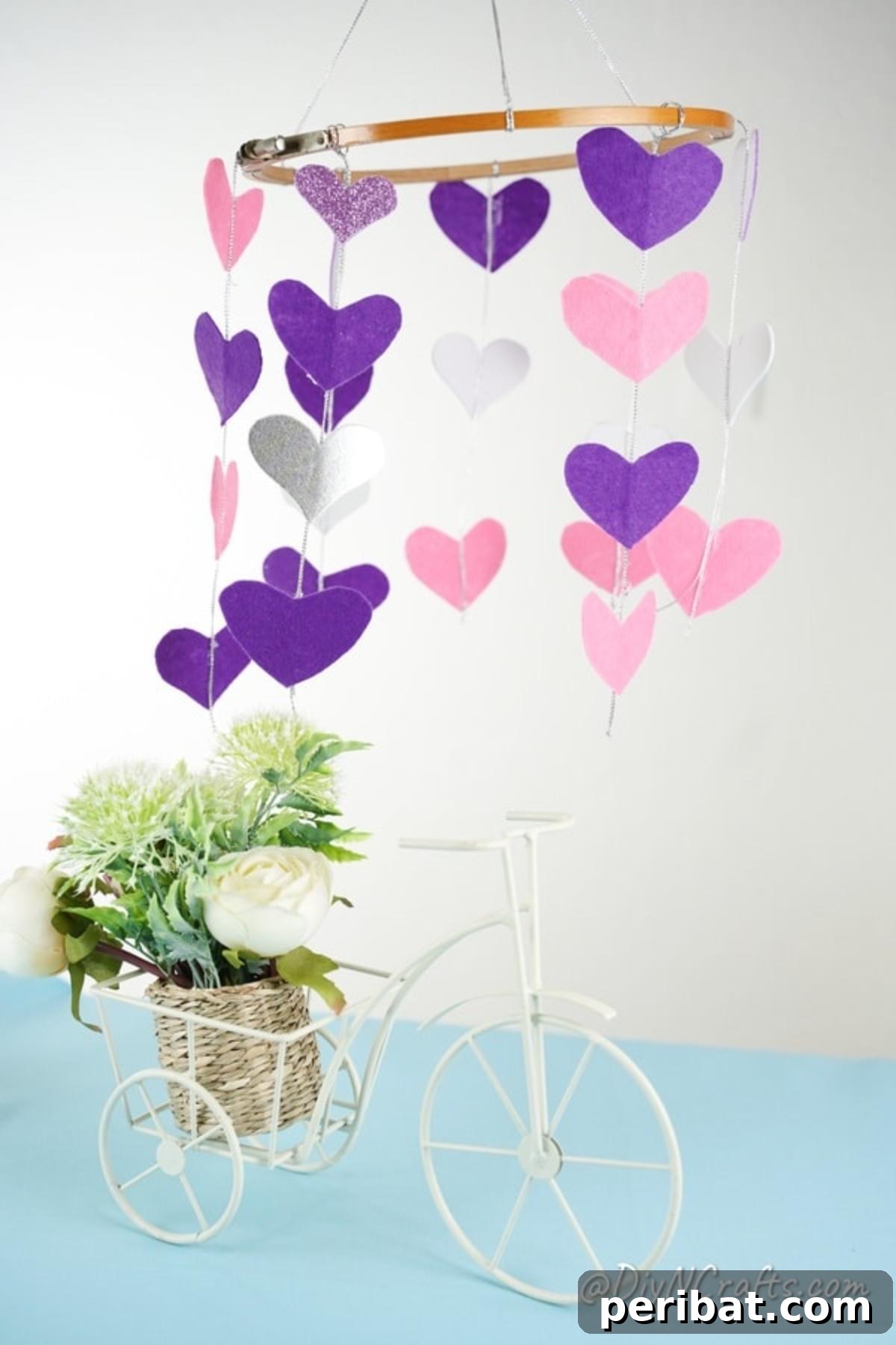Whimsical Valentine Heart Mobile 14 Paper herats mobile hanging above table