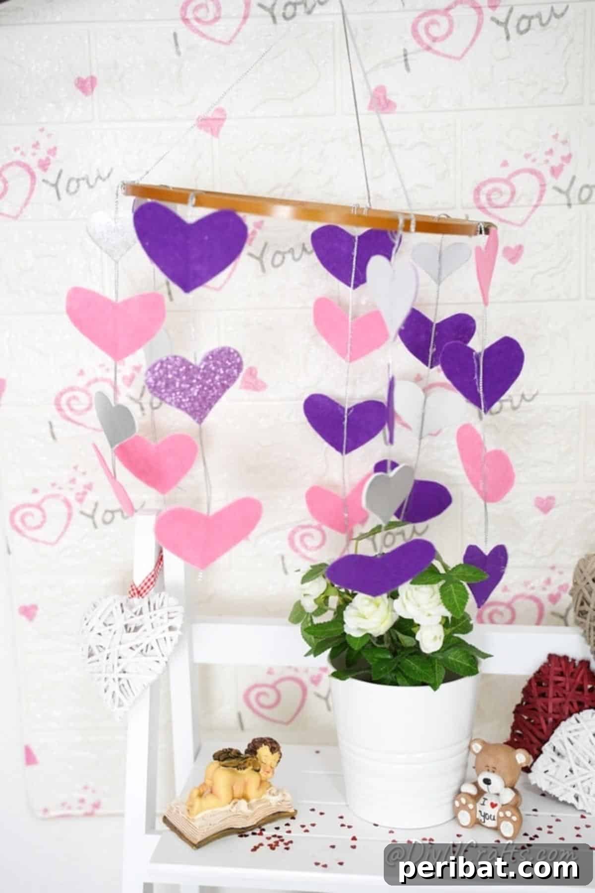 Whimsical Valentine Heart Mobile 3 Paper hearts mobile hanging above white shelf