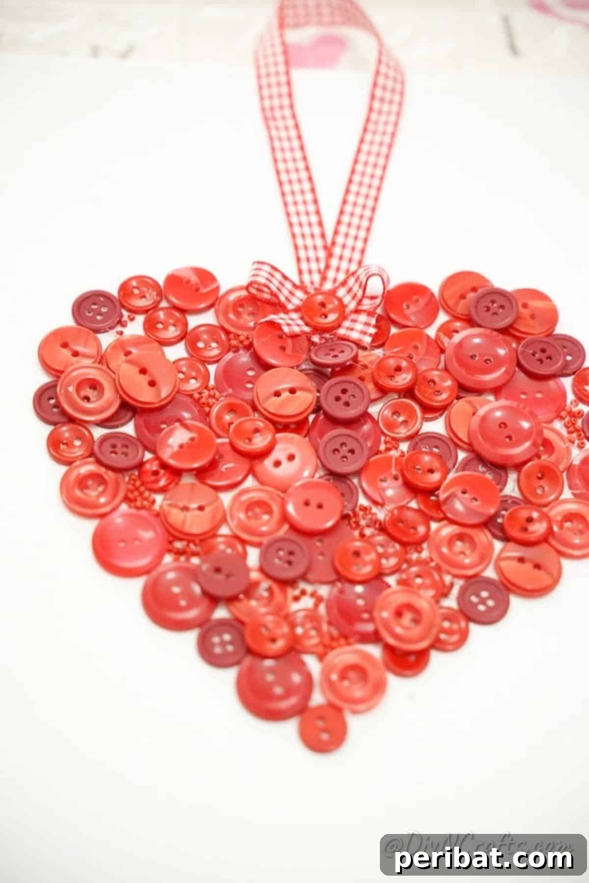 Charming Button Heart Canvas Decor 4 A vibrant button heart arrangement against a crisp white canvas, highlighting the varied textures and colors of the buttons.