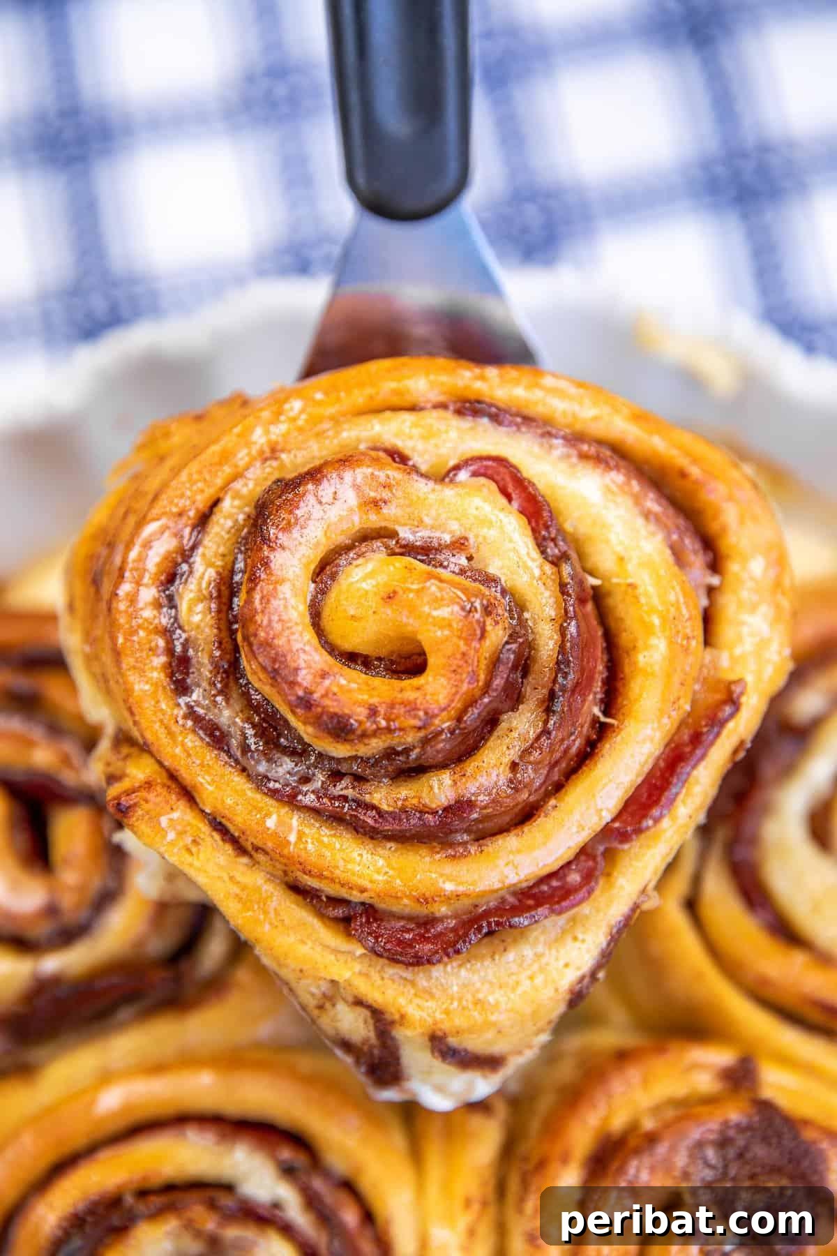 Bacon Beyond Belief: 26 Recipes for an Unforgettable Feast 12 Warm, gooey cinnamon rolls with a savory twist, incorporating crispy bacon bits into the filling.