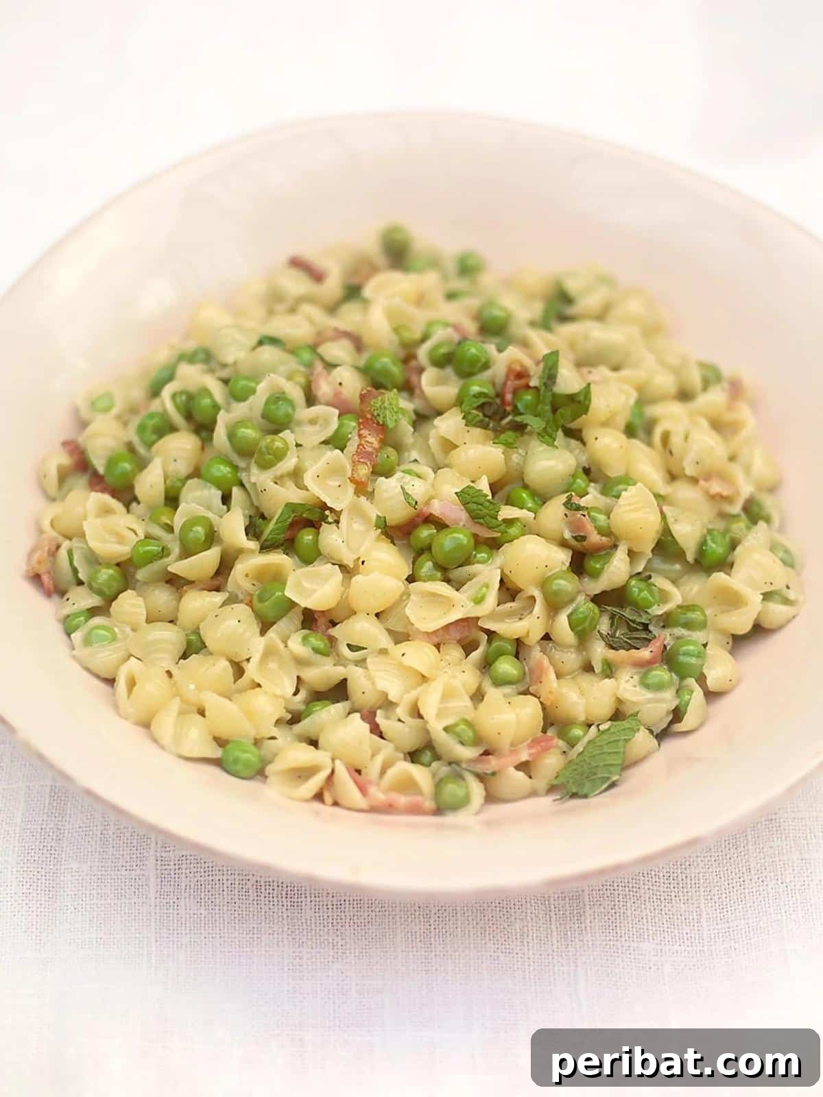 Bacon Beyond Belief: 26 Recipes for an Unforgettable Feast 17 A quick and easy pasta dish with a creamy, smoky sauce, green peas, and fresh mint.