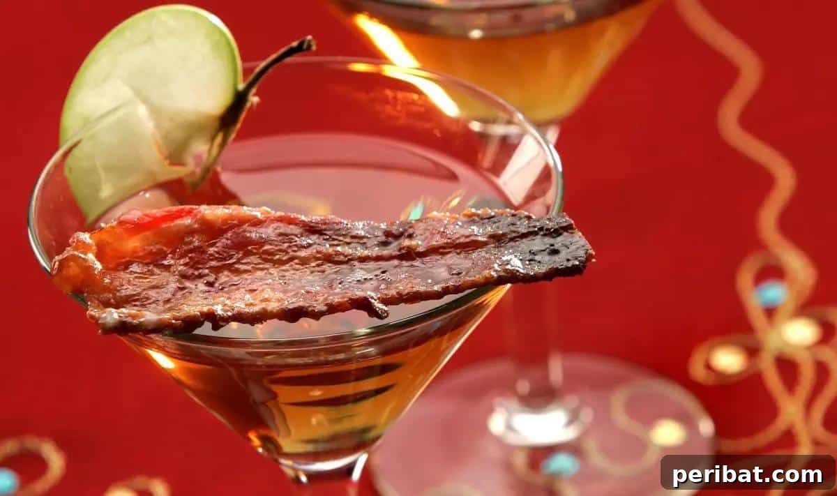 Bacon Beyond Belief: 26 Recipes for an Unforgettable Feast 19 A sophisticated martini garnished with a strip of sweet and salty candied bacon.