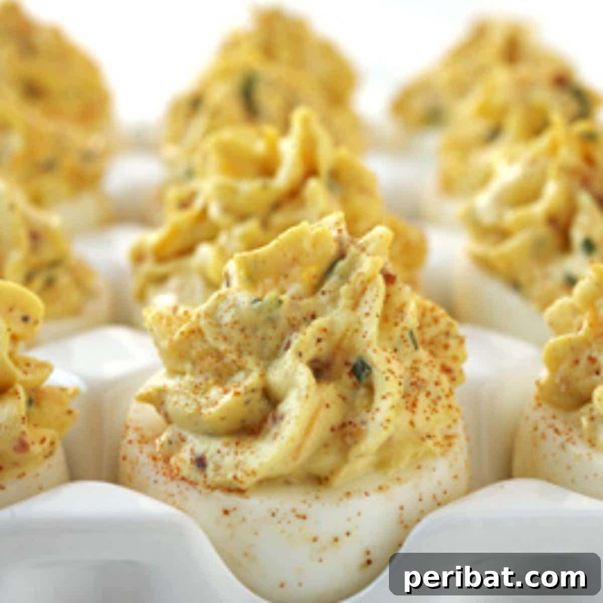 Bacon Beyond Belief: 26 Recipes for an Unforgettable Feast 6 Classic deviled eggs enhanced with crispy bacon bits, sharp cheddar cheese, and fresh green onions.