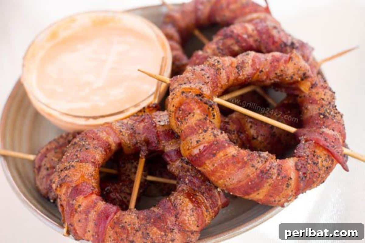 Bacon Beyond Belief: 26 Recipes for an Unforgettable Feast 7 Thick-cut onion rings wrapped in crispy bacon, grilled to perfection.