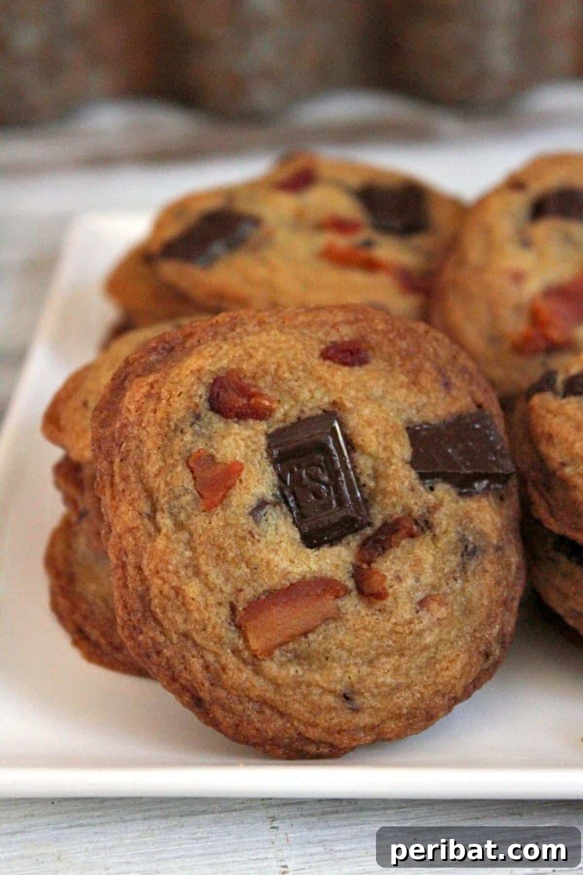 Bacon Beyond Belief: 26 Recipes for an Unforgettable Feast 8 Gourmet chocolate chunk cookies featuring the surprising combination of bourbon and crispy bacon bits.