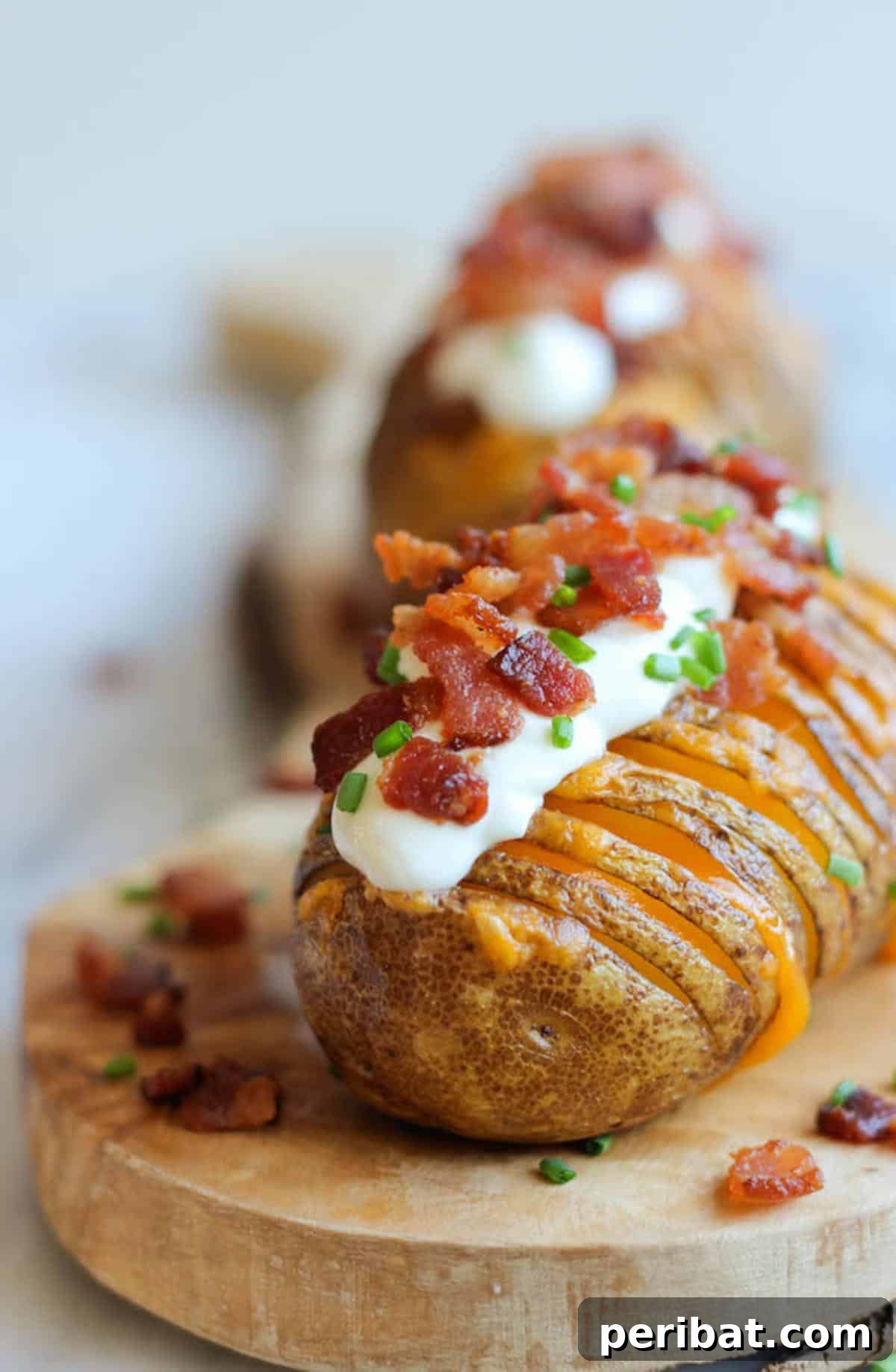 Bacon Beyond Belief: 26 Recipes for an Unforgettable Feast 9 Beautifully sliced hasselback potatoes, baked until crispy and loaded with melted cheddar, sour cream, and bacon bits.
