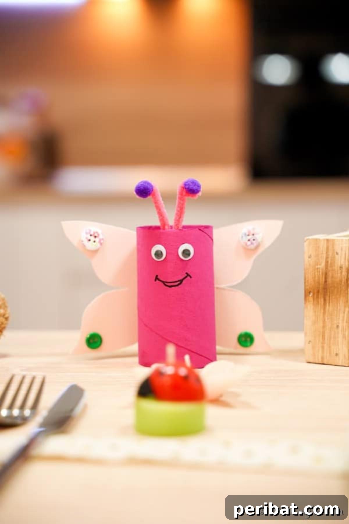Pink paper roll butterfly serving as a place setting decoration