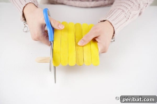 Colorful Craft Stick Chicken Painting 20 Trimming excess craft sticks for a neat chick shape.