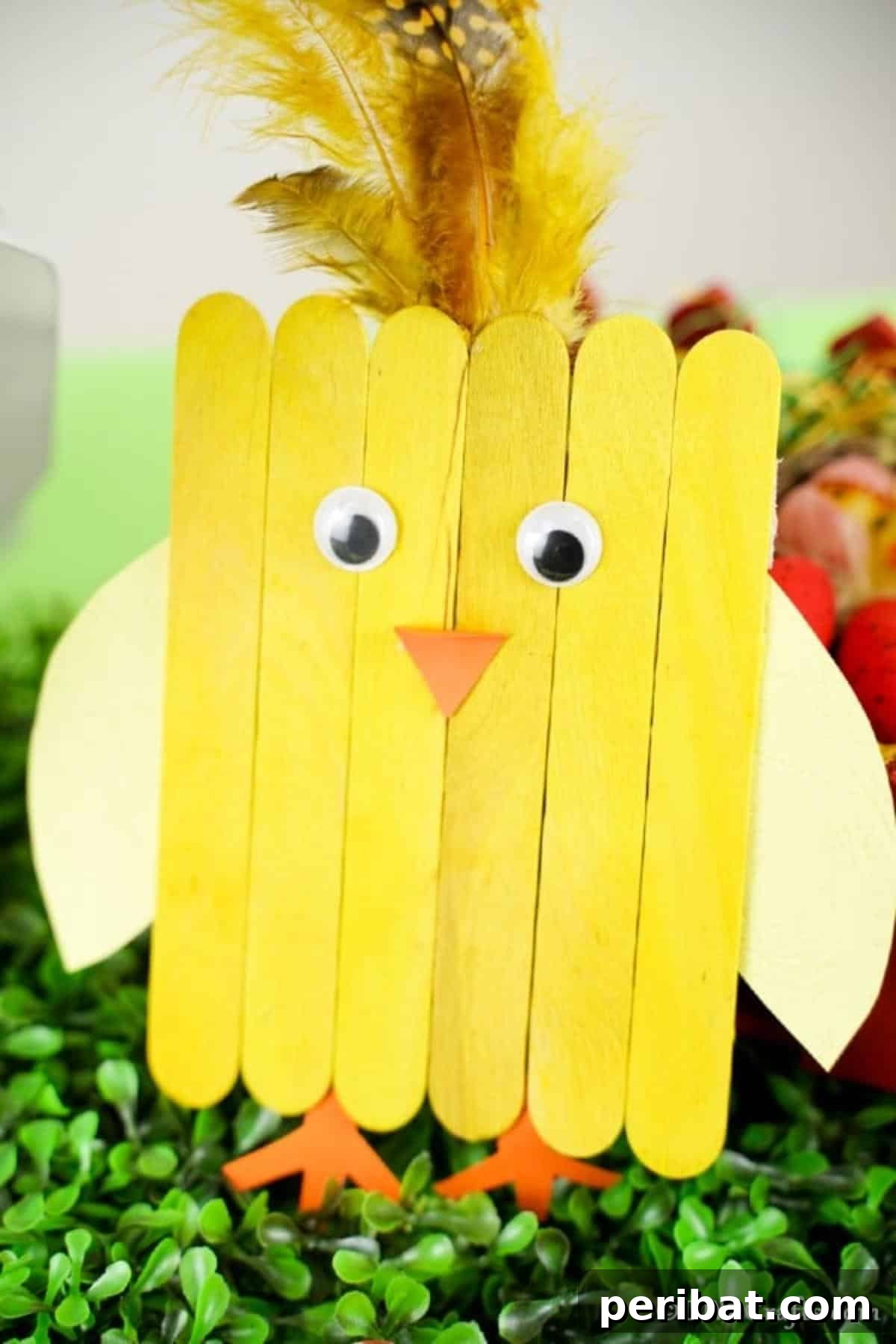 Colorful Craft Stick Chicken Painting 5 Adorable yellow popsicle stick chick leaning playfully against vibrant green grass, a symbol of spring's arrival.