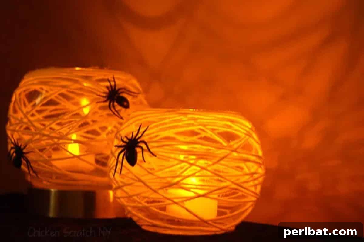 DIY Halloween: Craft Spine-Chilling Decor & Masterful Scares 15 Spider web themed votive candle holders casting spooky shadows, ideal for Halloween dining.