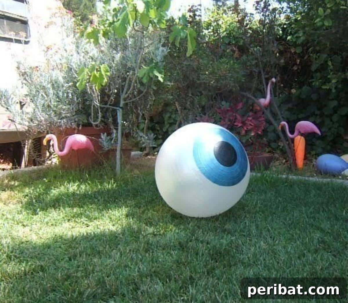 DIY Halloween: Craft Spine-Chilling Decor & Masterful Scares 22 A giant, creepy eyeball decoration made from a yoga ball, ideal for outdoor Halloween display.