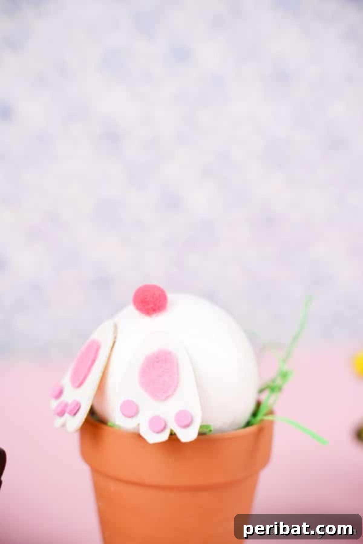 Easter Bunny Bloom Hideaway 3 Close-up of a finished Easter bunny flower pot craft against a cheerful pink background