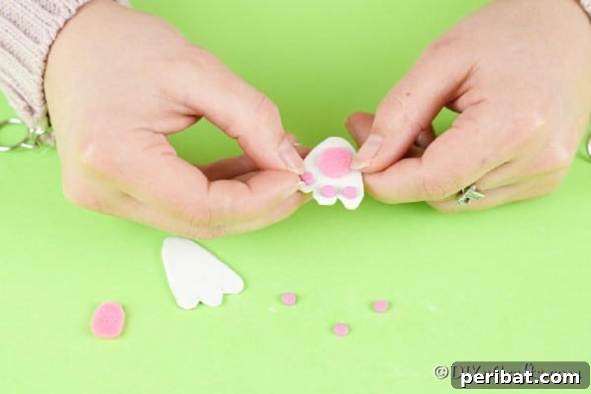 Easter Bunny Bloom Hideaway 10 Gluing smaller pink footpads and toe pads onto the white paper bunny feet