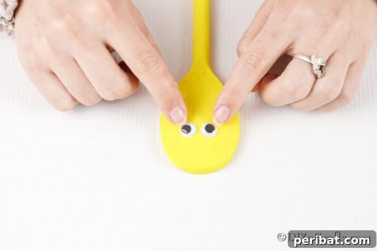 Adding eyes to yellow spoon