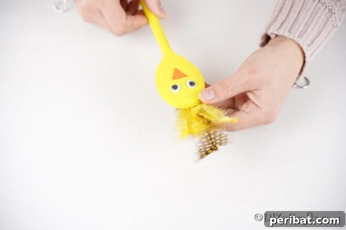 Adding feathers to yellow spoon