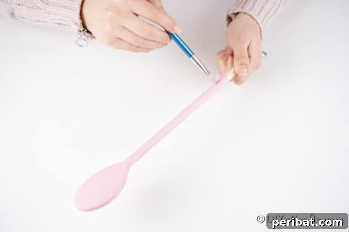 Painting wooden spoon pink