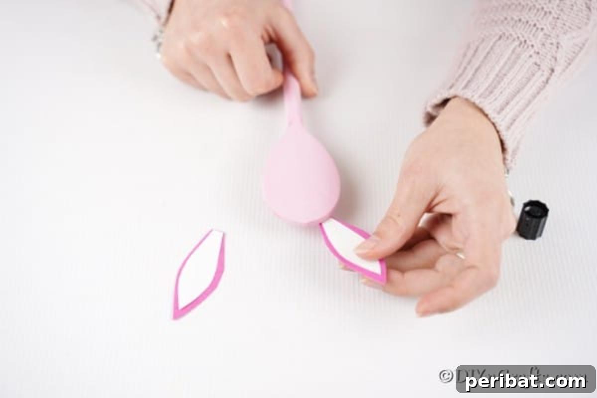 Gluing ears to pink spoon