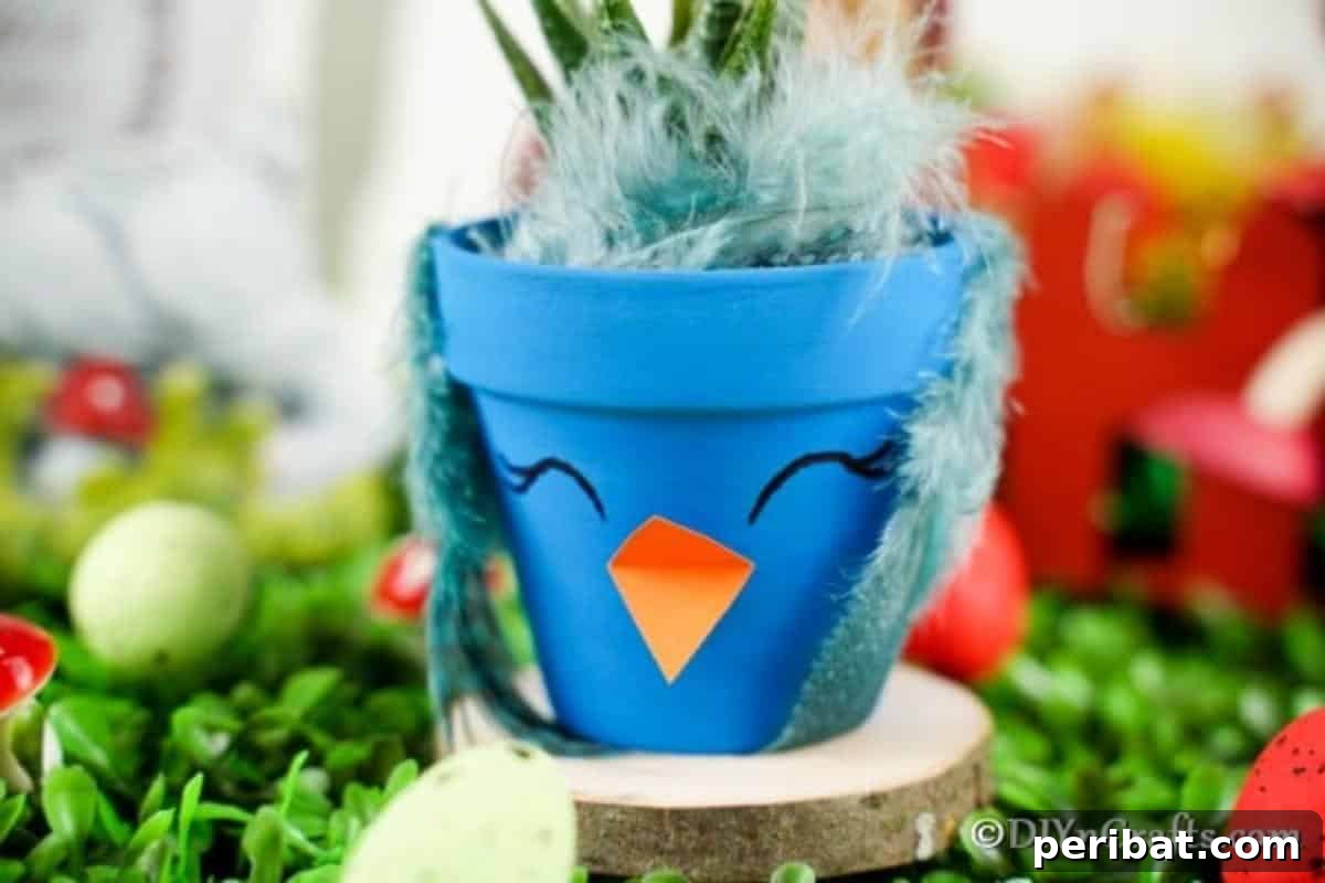 Whimsical Hand-Painted Bird Planter Charm 12 A finished blue flower pot bird sitting on a rustic wood slice