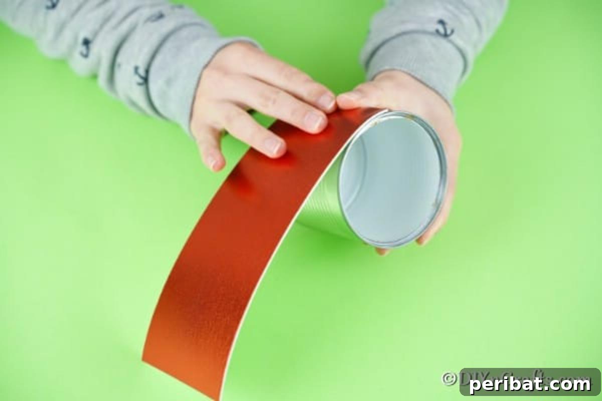 Adding the red foam wrap to the tin can