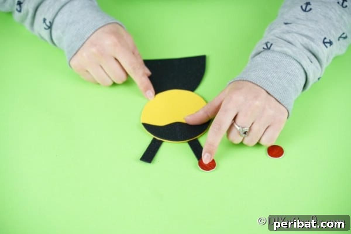Adding small red dots to the ladybug's antennae