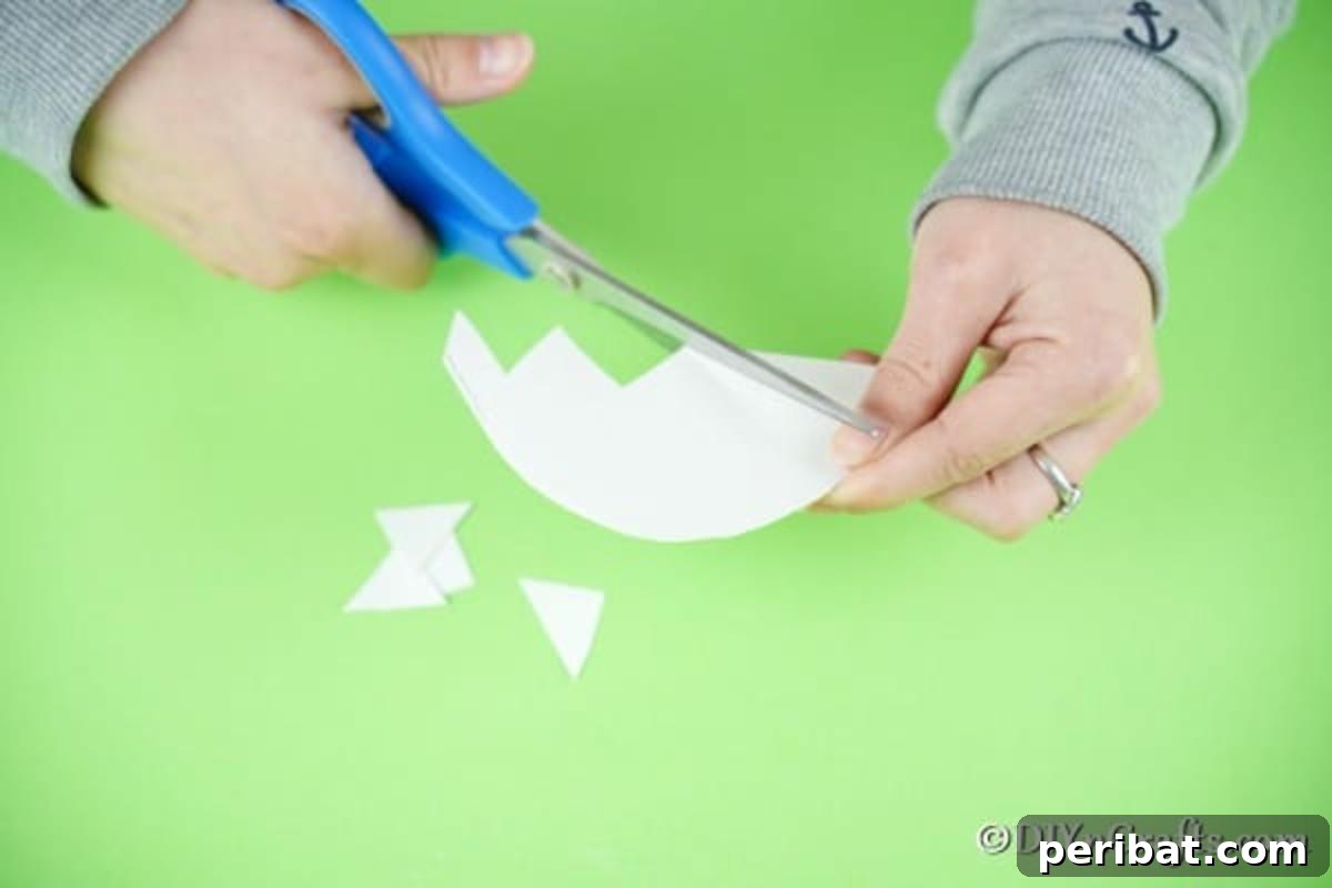 Trimming paper into cracked egg shape