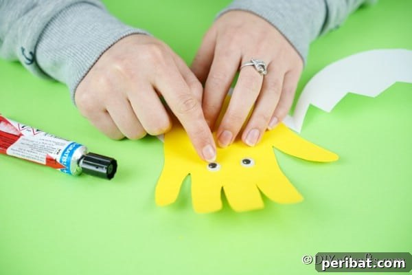 Adding googly eyes to handprint