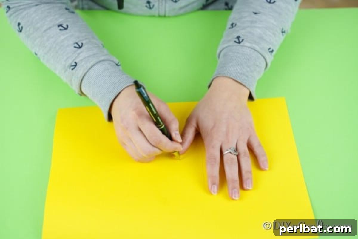 Tracing a hand on yellow paper