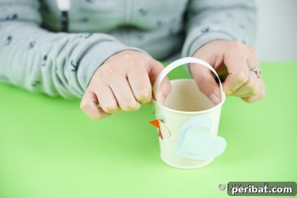 Simple Repurposed Bucket Spring Chicken 30 Gluing white paper handle to bucket
