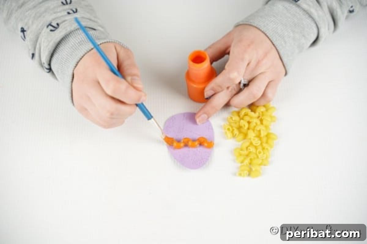 Whimsical Pasta Easter Egg Garland 13 A hand painting pasta pieces that are already glued onto paper eggs