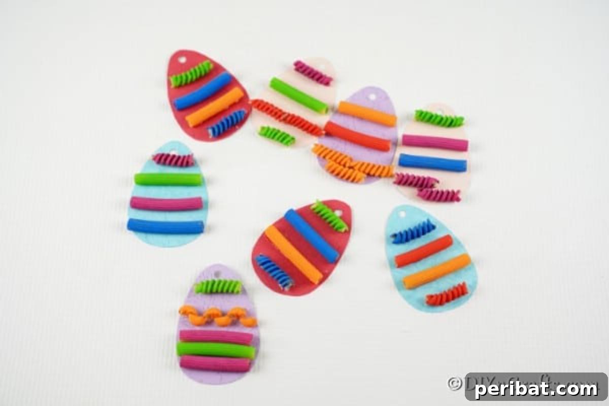 Whimsical Pasta Easter Egg Garland 16 A collection of completed pasta-painted egg pieces, vibrant and ready for assembly