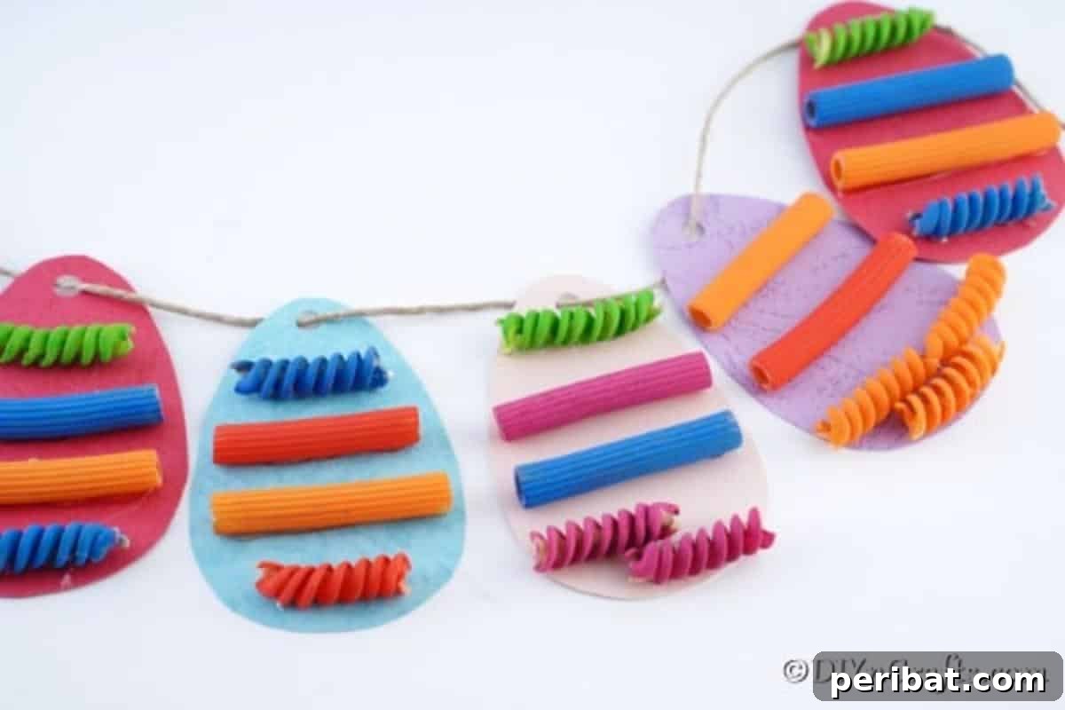 Whimsical Pasta Easter Egg Garland 4 A vibrant paper garland with artfully painted pasta pieces arranged on a clean white surface