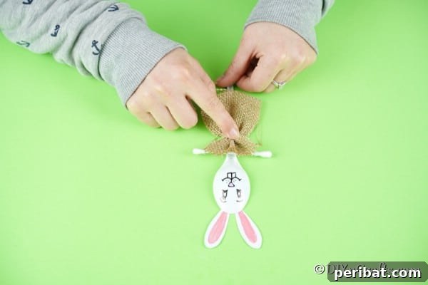 Adorable Upcycled Spoon Bunnies for Easter 24 Gluing bow and q-tip onto spoon to make girl bunny
