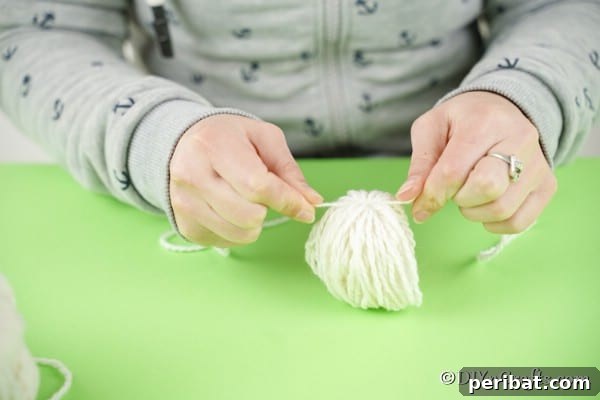 Whimsical Nordic Easter Gnome Creation 21 Tying yarn around middle of yarn ball
