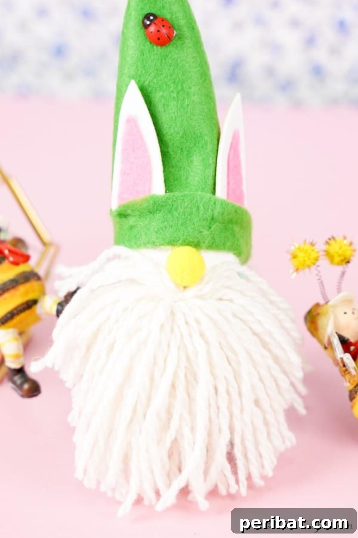 Whimsical Nordic Easter Gnome Creation 4 A cute Easter gnome with a bright green hat and white beard, standing on a soft pink surface, ready for display.