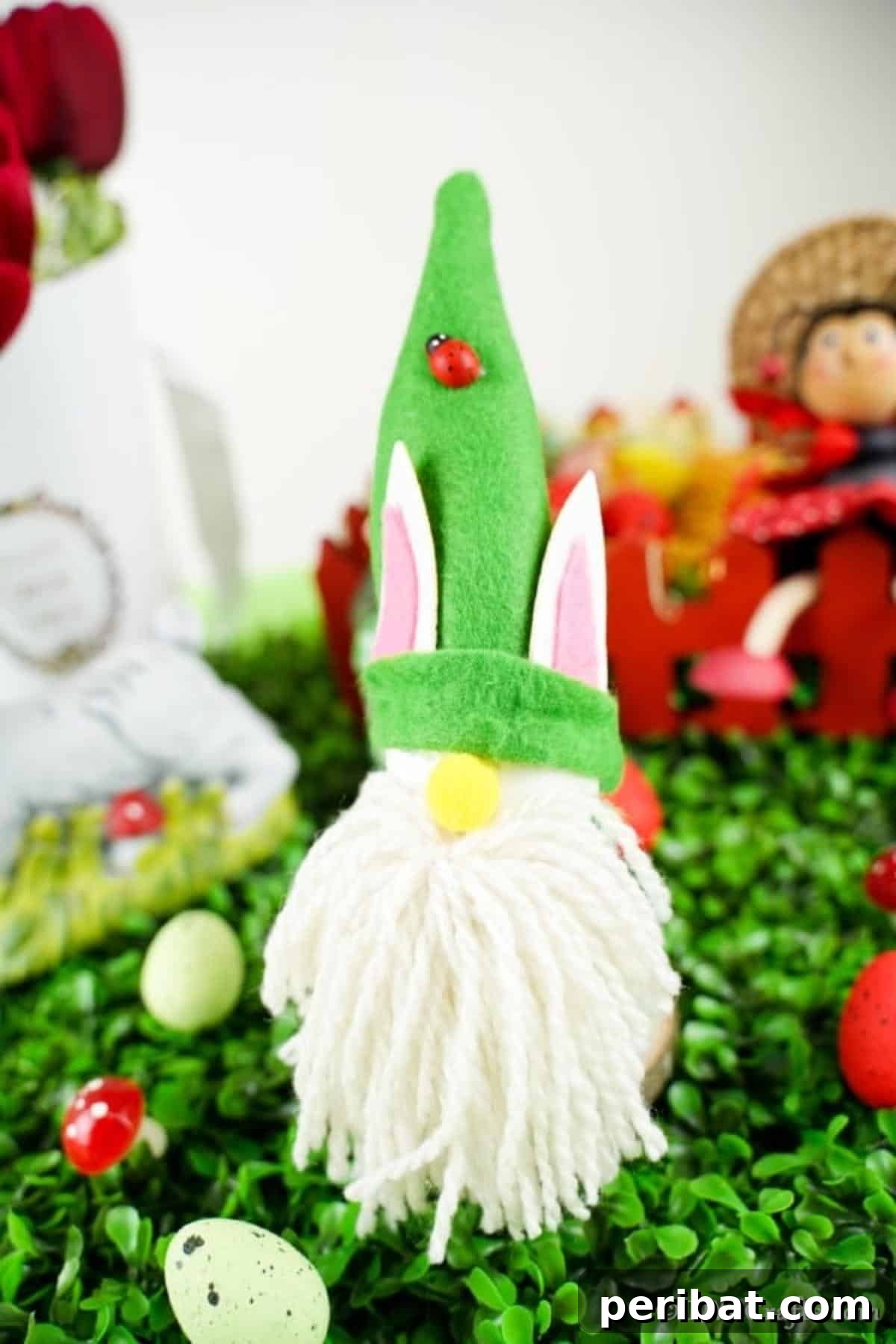 Whimsical Nordic Easter Gnome Creation 5 An Easter gnome with a green hat and white beard, sitting on artificial green grass, symbolizing outdoor spring decor.