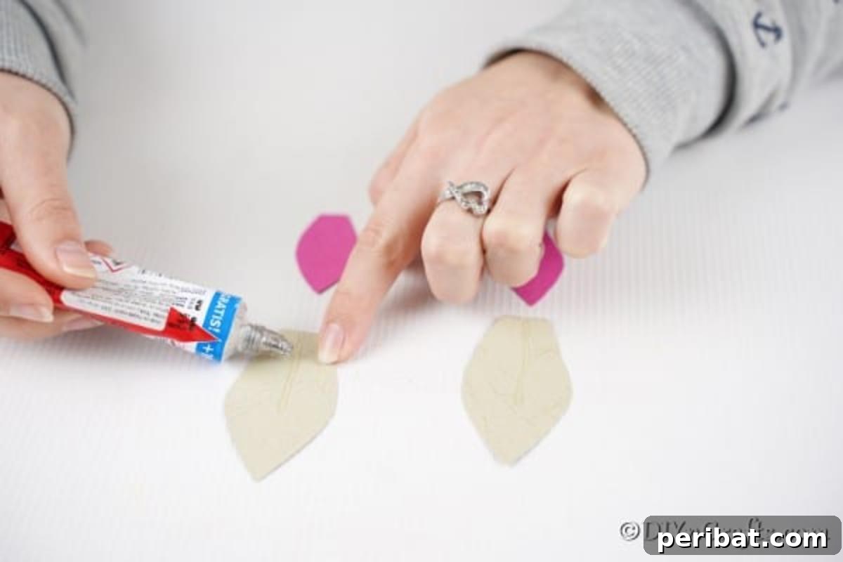 DIY Easter Treat Pouch Video Guide 15 Various white and pink paper shapes laid out, showing the process of making bunny ears