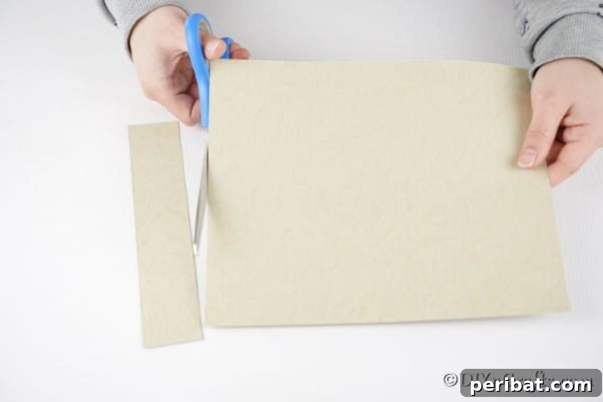 DIY Easter Treat Pouch Video Guide 8 A hand cutting excess strips from a piece of paper, leaving a neat square